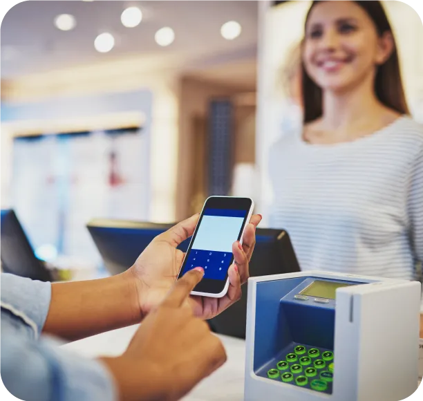 Customer paying with a phone at a store counter